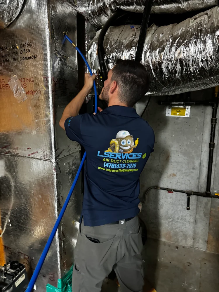 professional in blue LServices shirt cleaning air duct